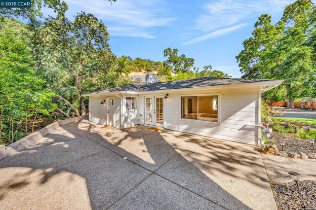 an aerial view of residential house with outdoor space and trees around