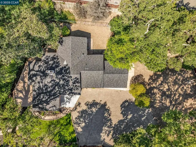 a kitchen with granite countertop a sink a toilet and a window