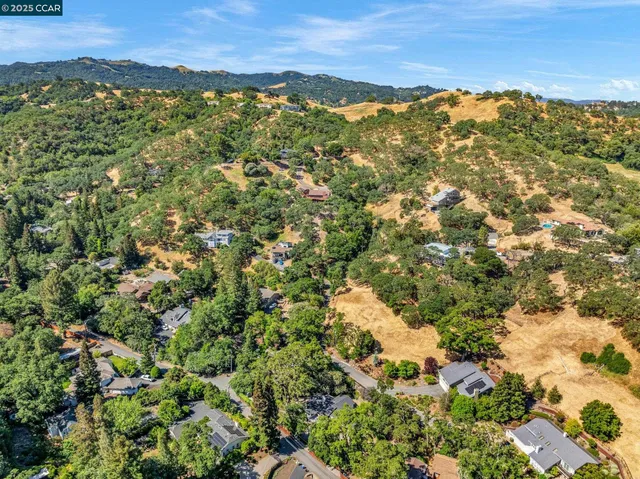 an empty room with windows and fireplace