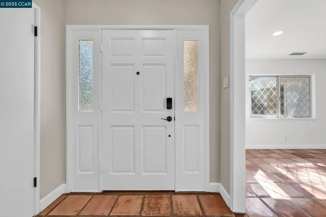 a living room with couches rug and a window