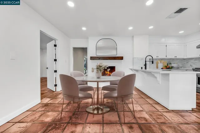 a kitchen with stainless steel appliances a refrigerator sink and cabinets