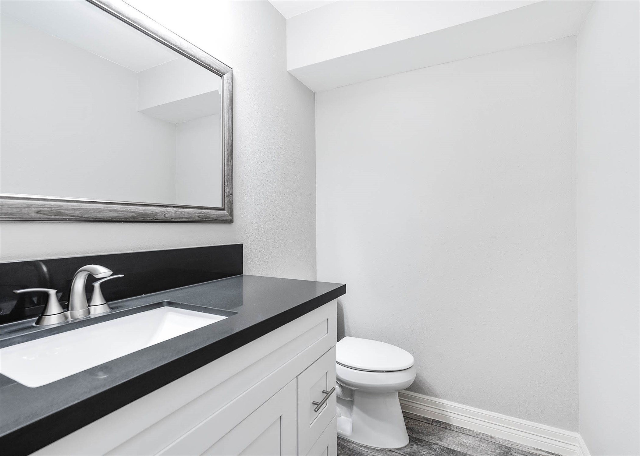 5528 Beverly Hill Street, Unit 1 Houston, TX 77056 - Photo 12 of 22 a bathroom with a sink and a toilet