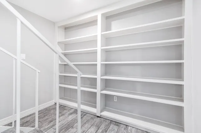 a view of walk in closet with empty racks