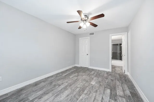 a view of an empty room and wooden floor