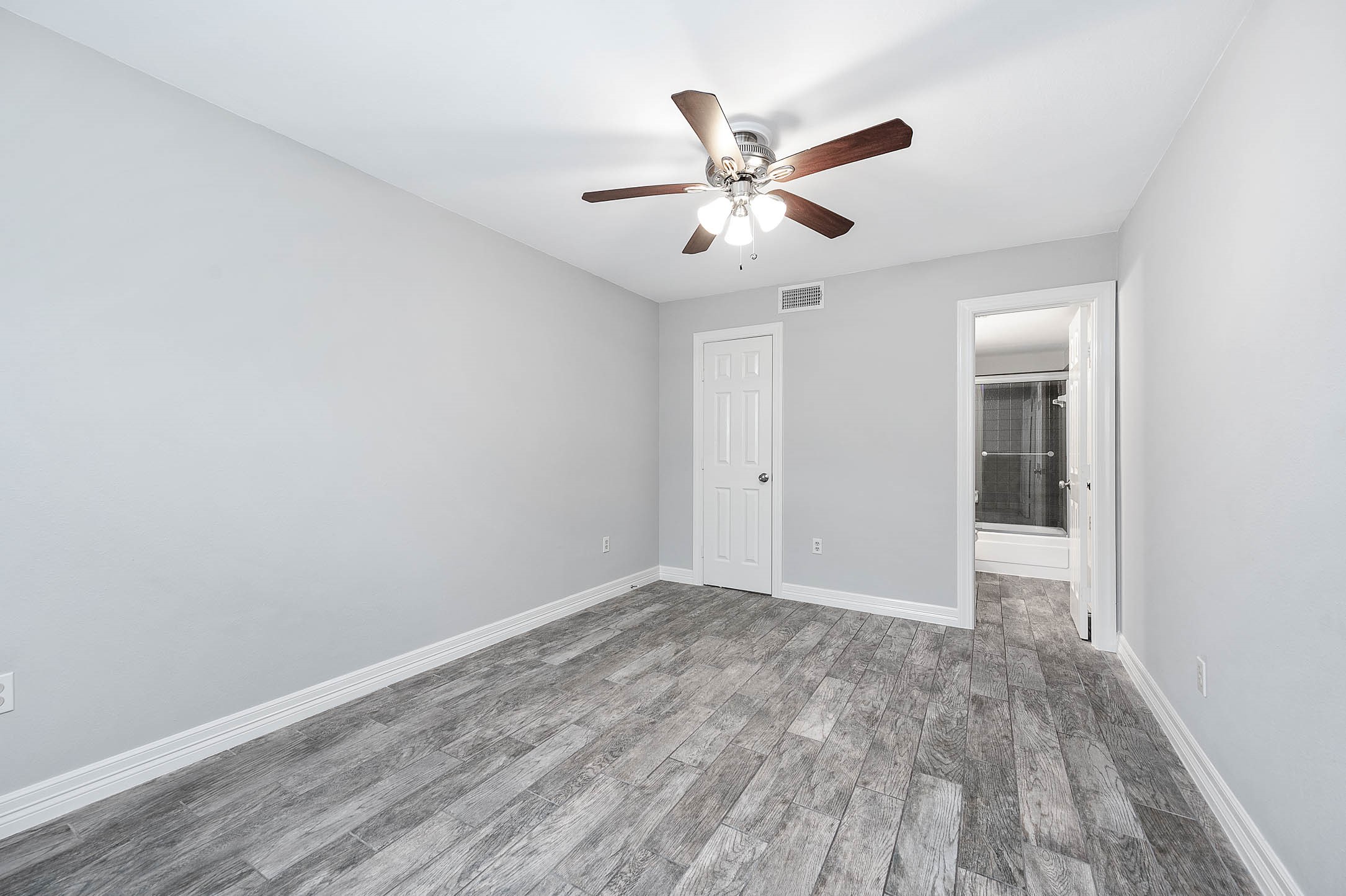 5528 Beverly Hill Street, Unit 1 Houston, TX 77056 - Photo 18 of 22 a view of an empty room and wooden floor