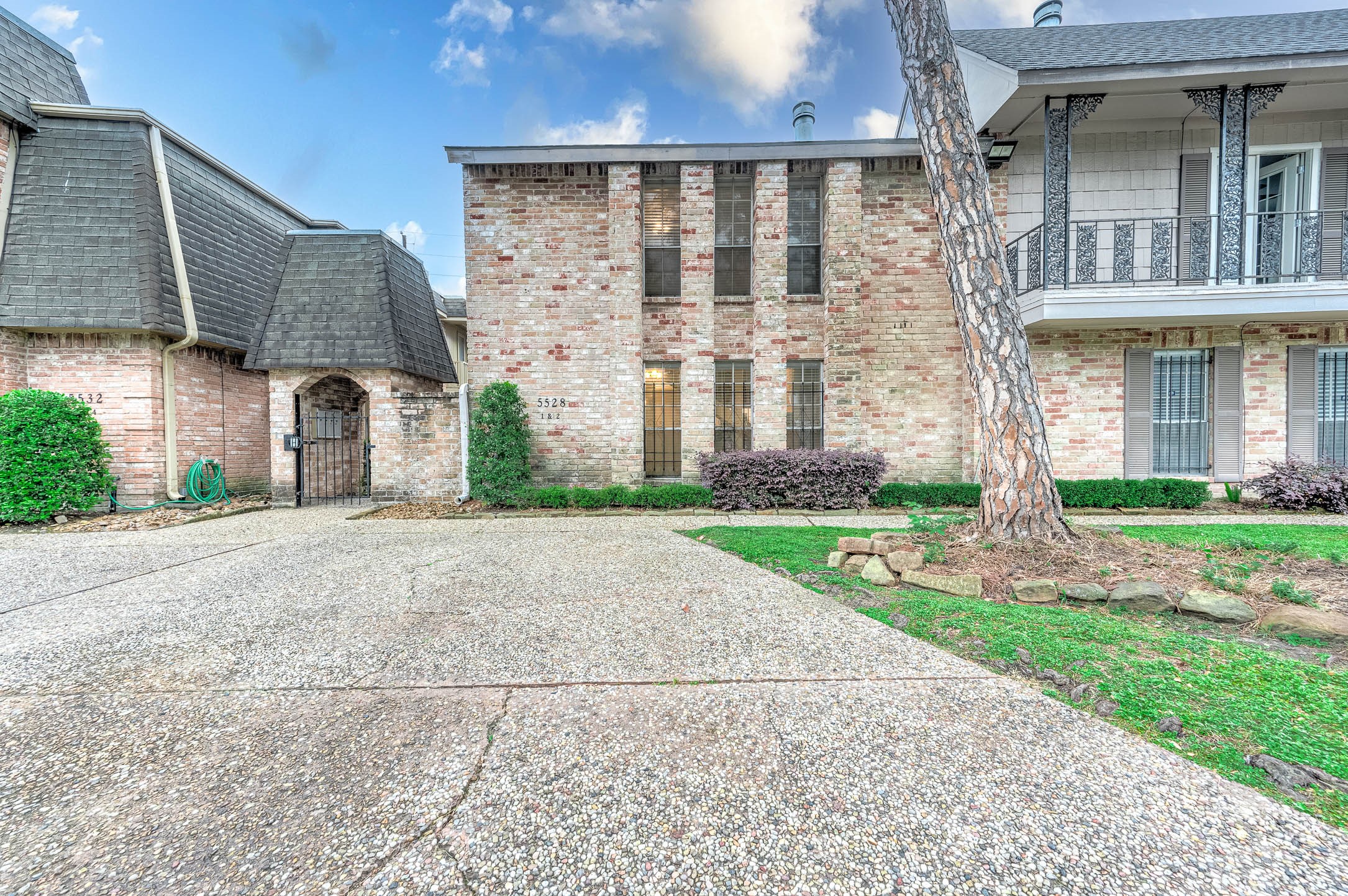 5528 Beverly Hill Street, Unit 1 Houston, TX 77056 - Photo 22 of 22 a front view of a house with garden