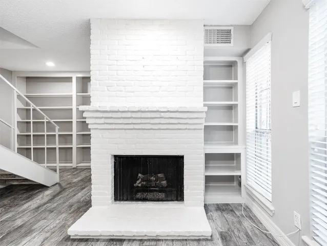 a living room with a fireplace and a window