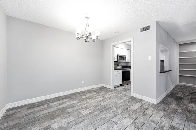 a view of a kitchen with refrigerator and an oven