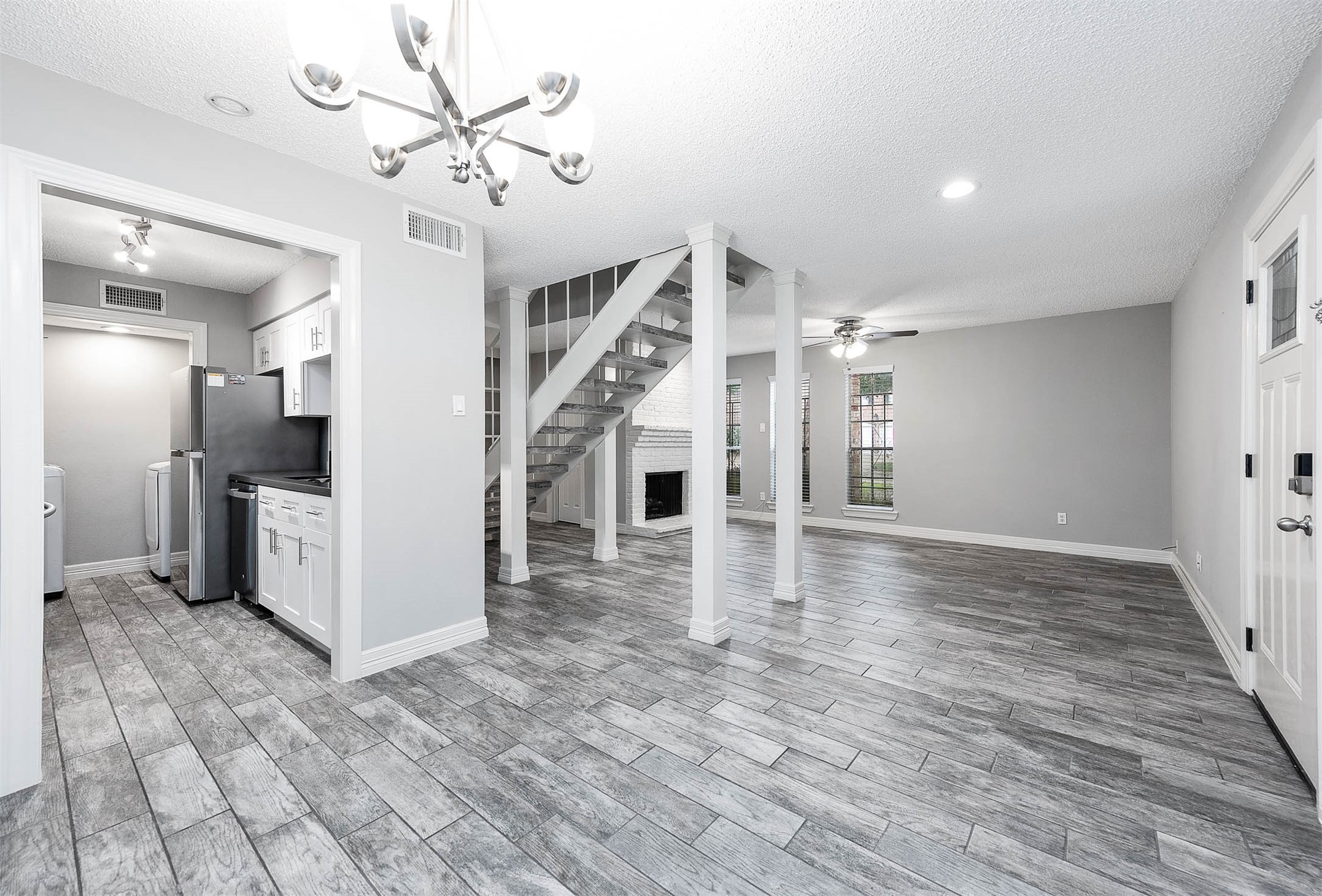 5528 Beverly Hill Street, Unit 1 Houston, TX 77056 - Photo 6 of 22 a view of a livingroom with wooden floor and a ceiling fan
