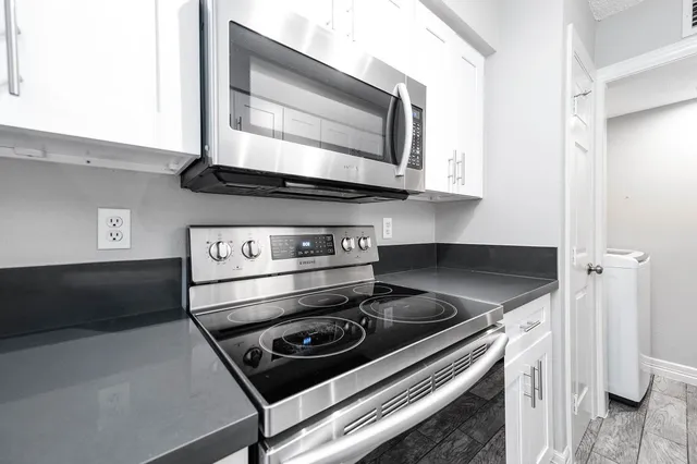 a stove top oven sitting inside of a kitchen