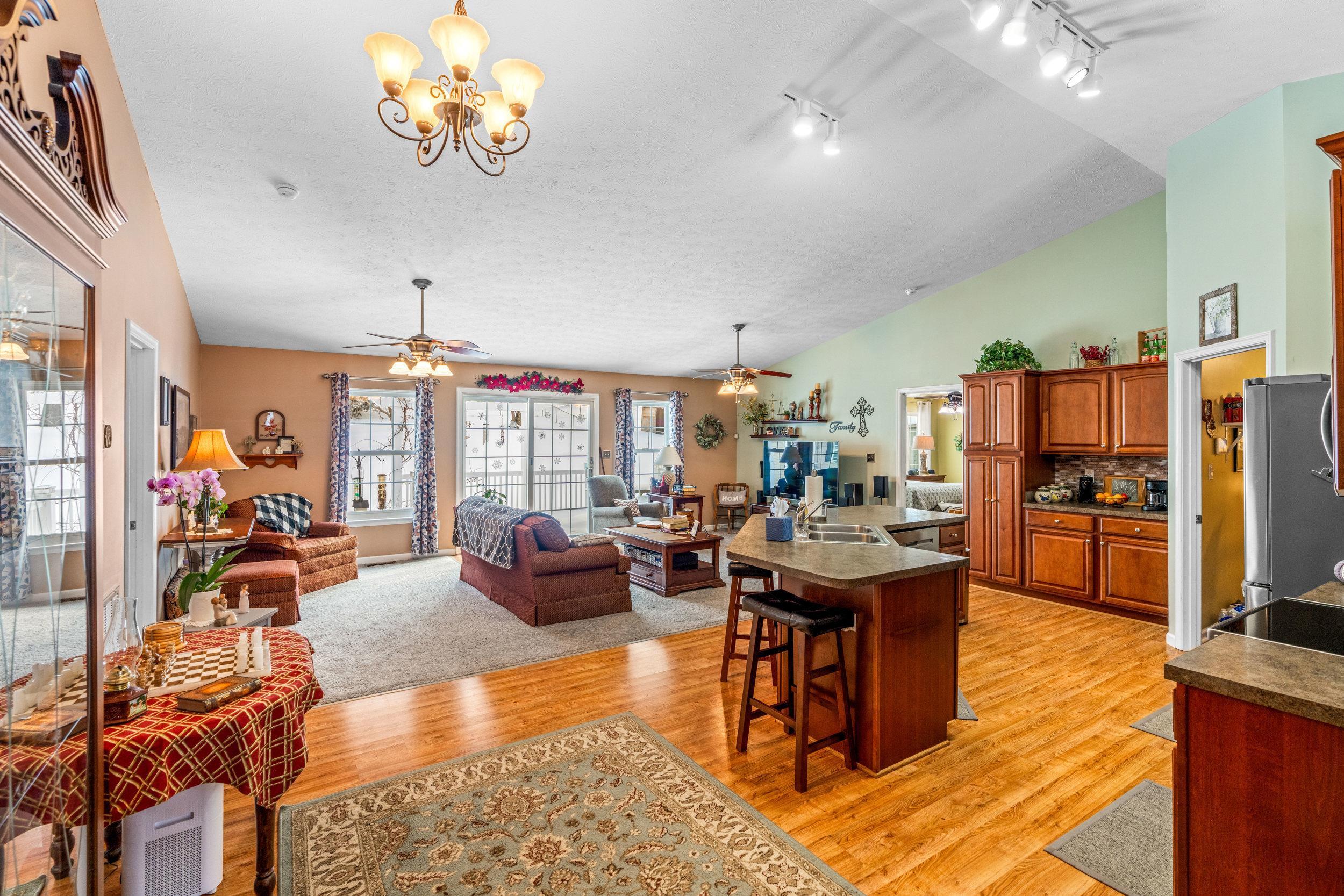 901 Ritchie Boulevard Staunton, VA 24401 - Photo 15 of 36 a living room with lots of furniture kitchen view and a chandelier