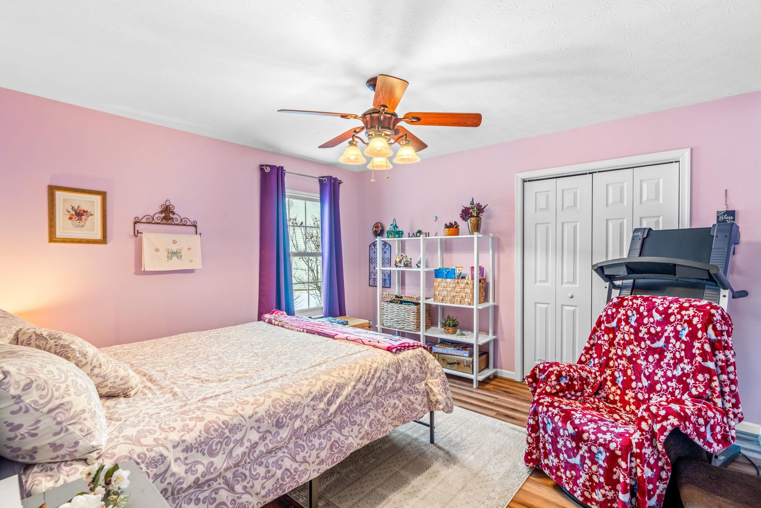 901 Ritchie Boulevard Staunton, VA 24401 - Photo 17 of 36 a bedroom with a bed and a chandelier