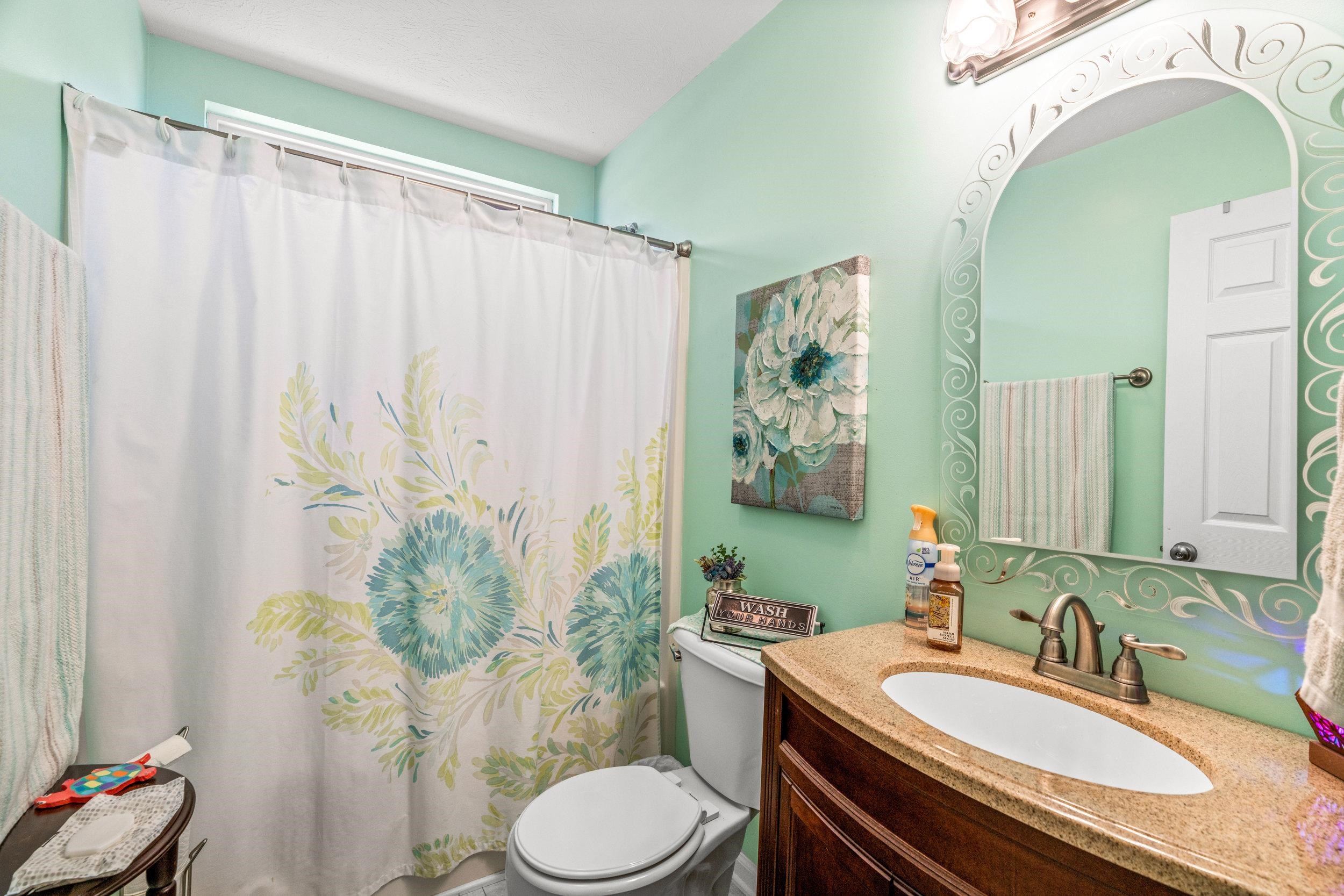 901 Ritchie Boulevard Staunton, VA 24401 - Photo 22 of 36 a bathroom with a granite countertop sink a toilet and a mirror