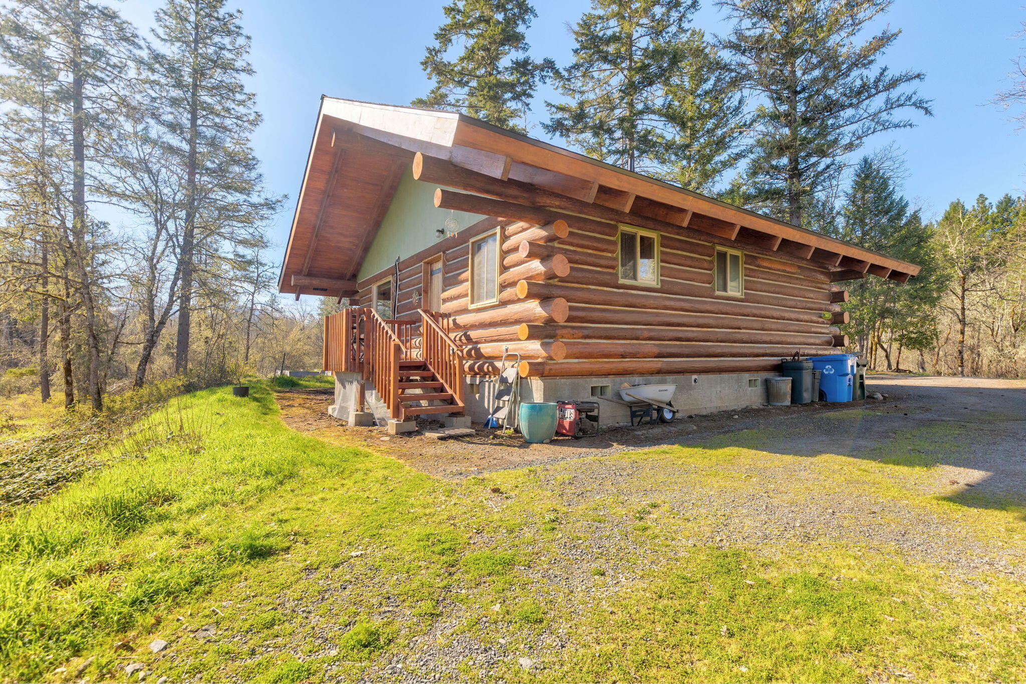 5737 Rockydale Road Cave Junction, OR 97523 - Photo 36 of 39 a view of a house with yard and sitting area