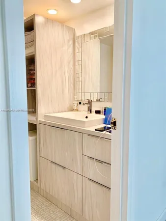 a kitchen with a sink and a refrigerator