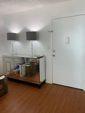a kitchen with kitchen island a stove and a wooden floor