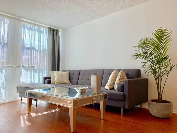 a living room with furniture and a potted plant