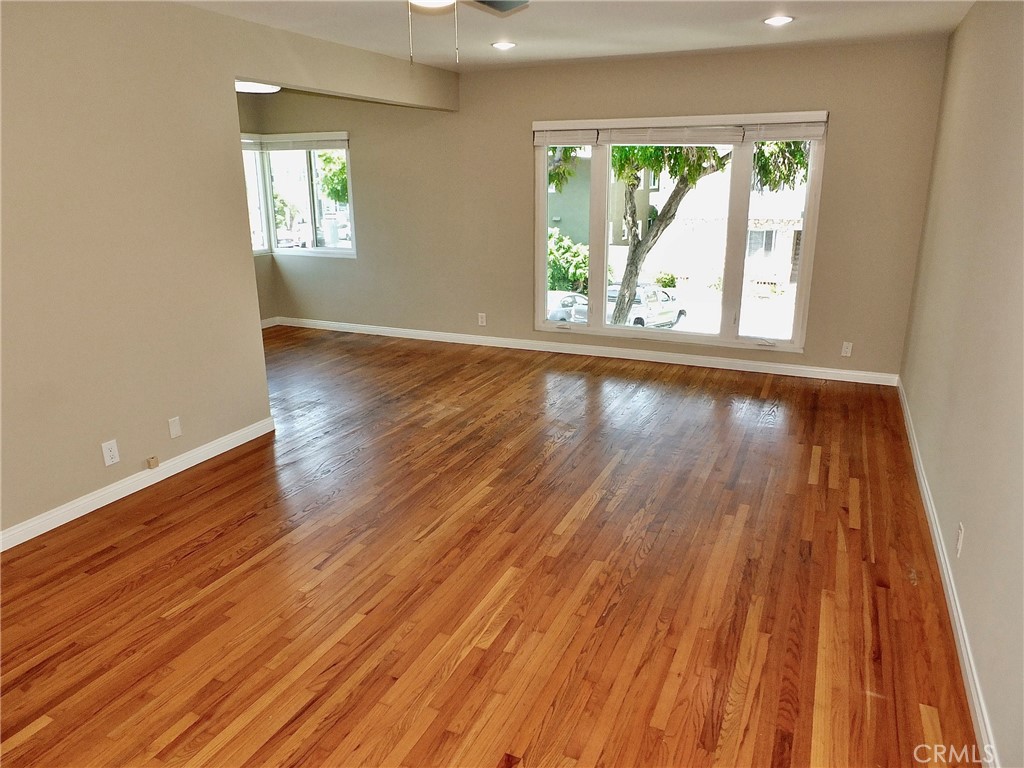 1808 East Appleton Street, Unit 7 Long Beach, CA 90802 - Photo 11 of 44 an empty room with wooden floor and windows
