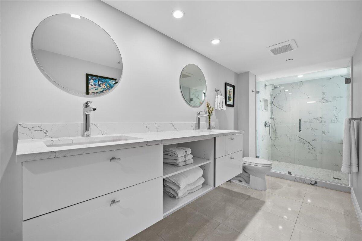4000 North Ocean Drive, Unit 2004 Singer Island, FL 33404 - Photo 17 of 54 a bathroom with a double vanity sink mirror and shower