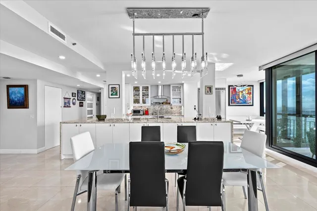 a large kitchen with a table and chairs