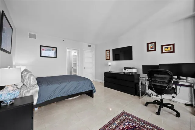 a bedroom with a large bed and a large window