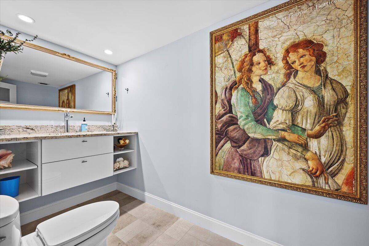 4000 North Ocean Drive, Unit 2004 Singer Island, FL 33404 - Photo 24 of 54 a bathroom with a toilet a sink and wooden floor