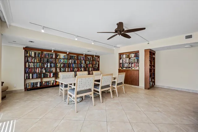 a dining room with furniture a rug potted plants and wooden floor