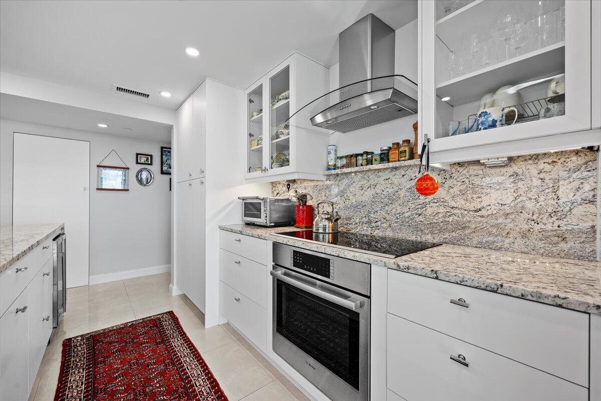 4000 North Ocean Drive, Unit 2004 Singer Island, FL 33404 - Photo 5 of 54 a kitchen with stainless steel appliances granite countertop cabinets and a wooden floor