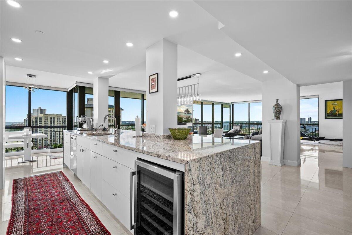 4000 North Ocean Drive, Unit 2004 Singer Island, FL 33404 - Photo 7 of 54 a large kitchen with stainless steel appliances kitchen island granite countertop a large counter top and sink