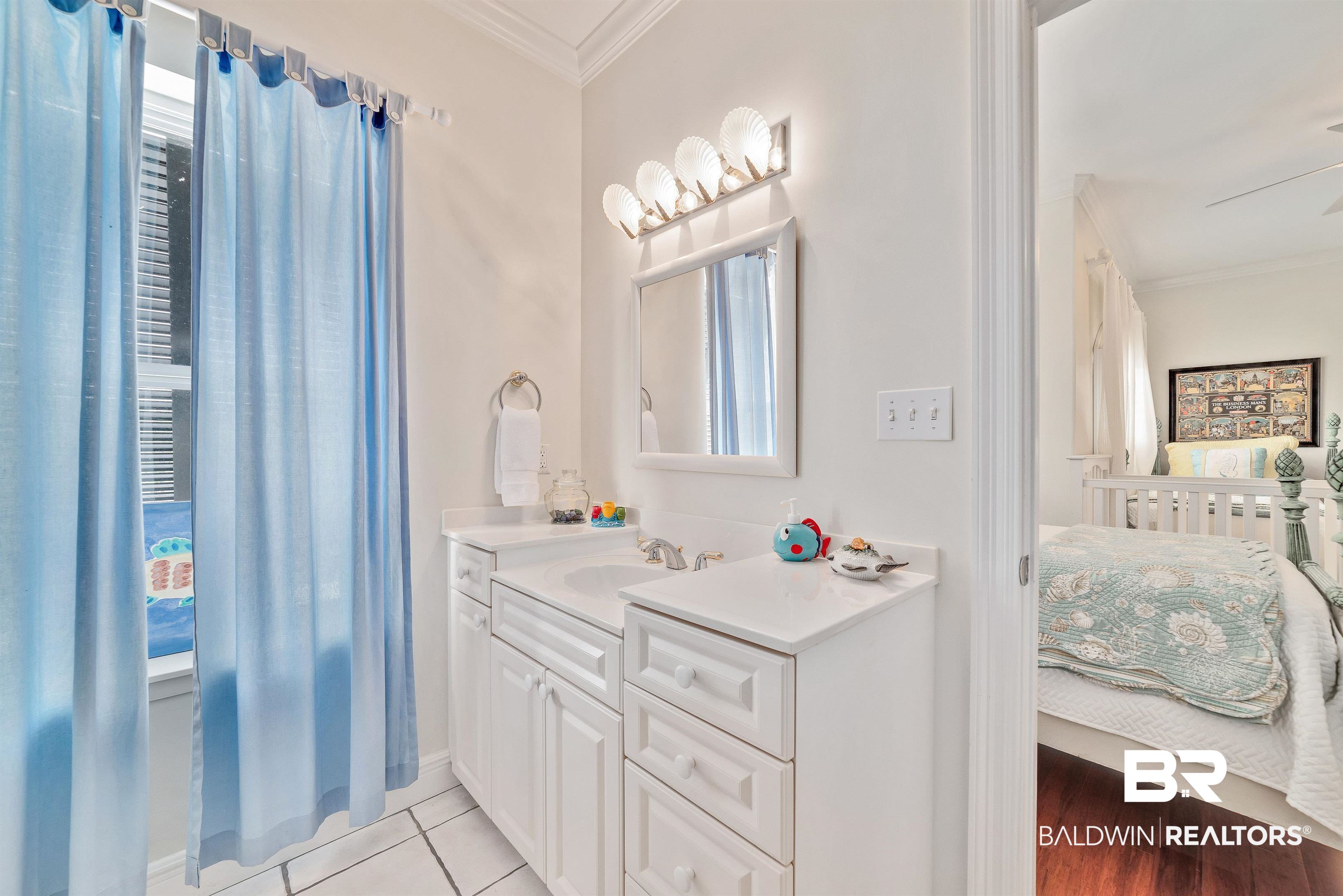 24513 Gulf Bay Road Orange Beach, AL 36561 - Photo 29 of 52 Bathroom with vanity, hardwood / wood-style flooring, and ornamental molding