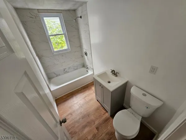 a white toilet sitting next to a bath tub