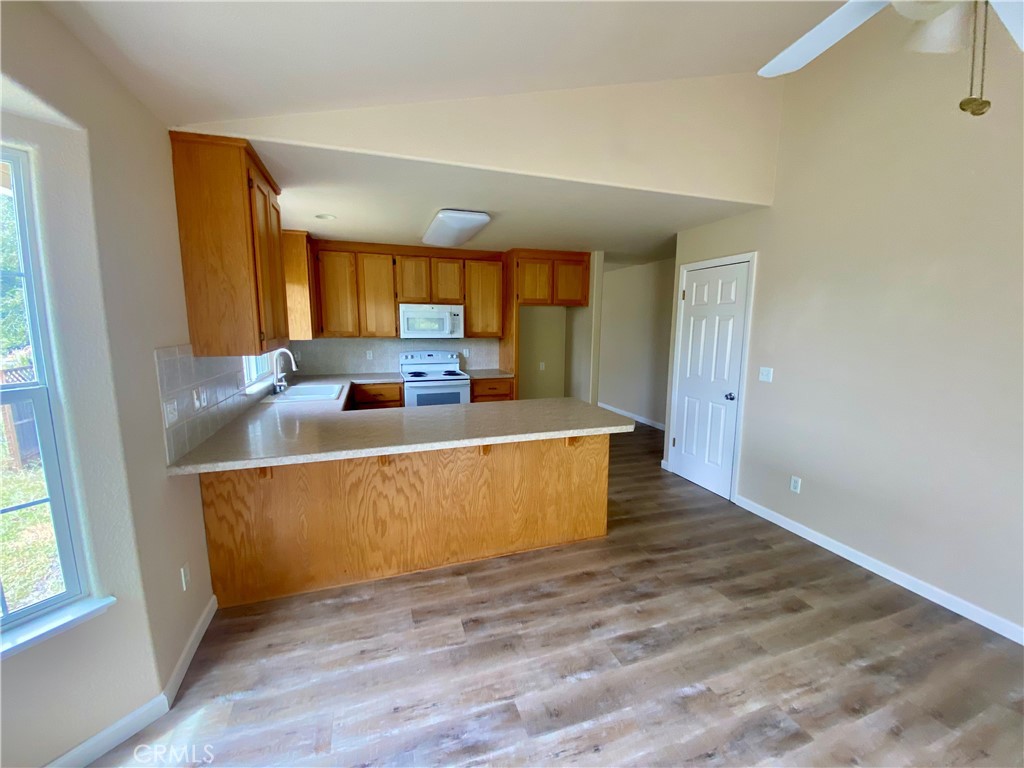 16506 Ridgecrest Court Hidden Valley Lake, CA 95467 - Photo 7 of 25 a living room with furniture and a wooden floor
