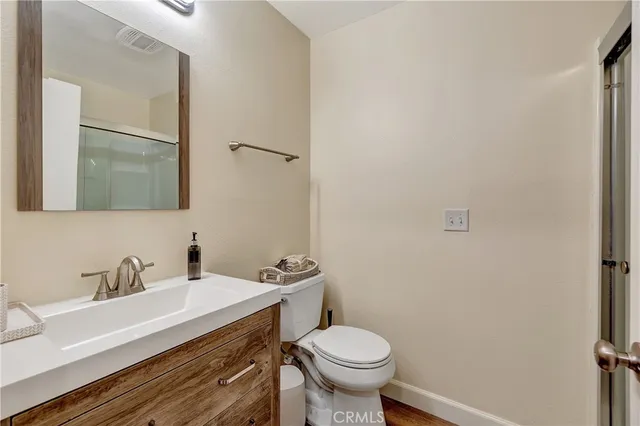 a bathroom with a sink toilet and mirror