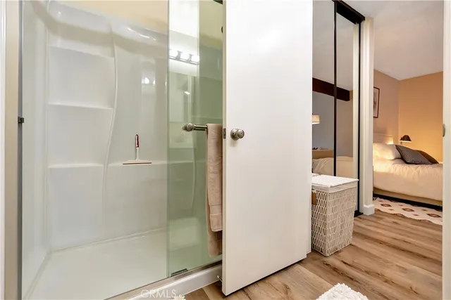 a bathroom with a glass door shower and a sink