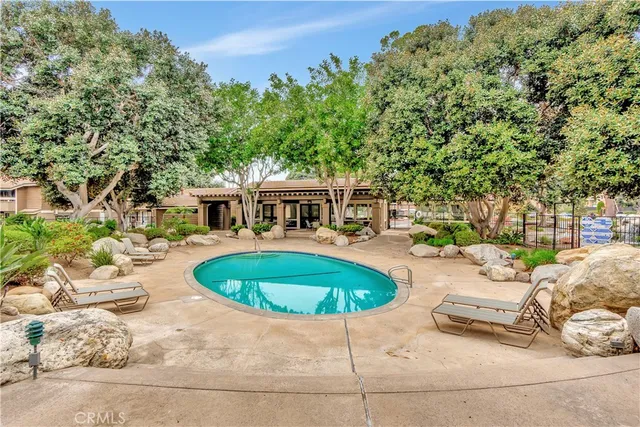 a swimming pool with outdoor seating and yard