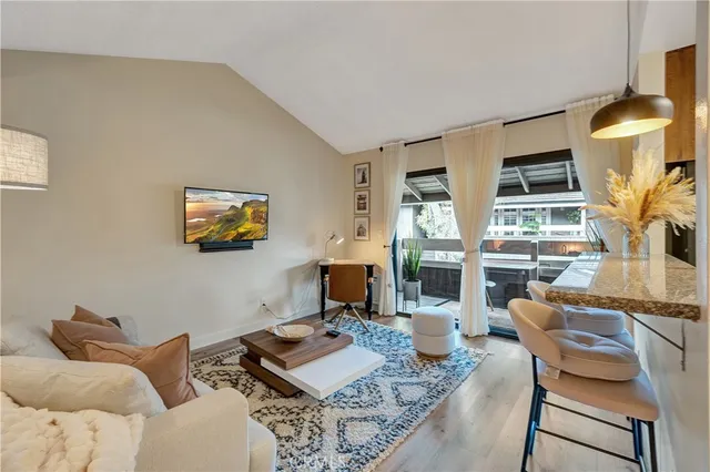 a living room with fireplace furniture and a floor to ceiling window