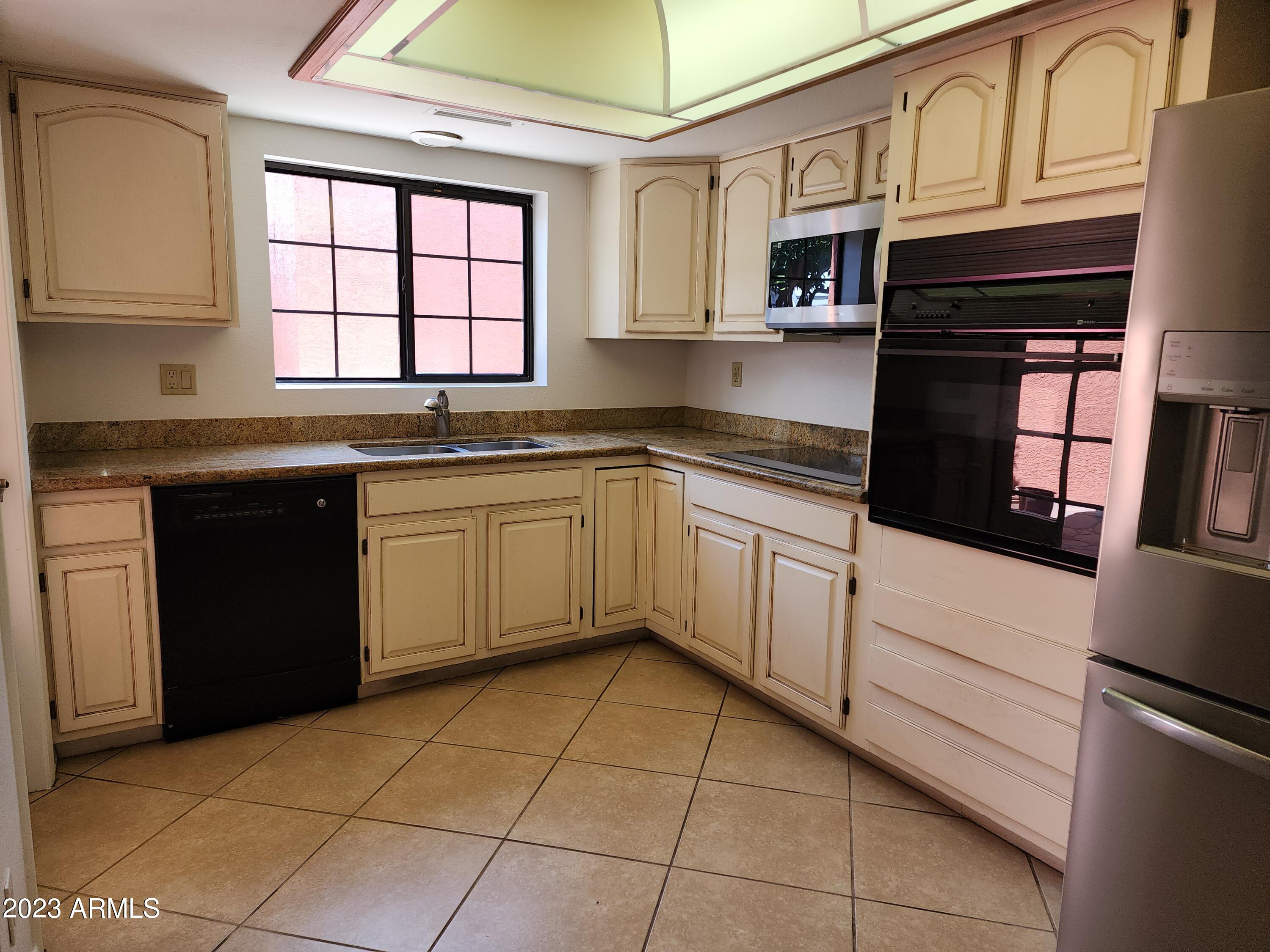 517 West Knox Road Chandler, AZ 85225 - Photo 11 of 14 a kitchen with stainless steel appliances granite countertop a stove sink and cabinets