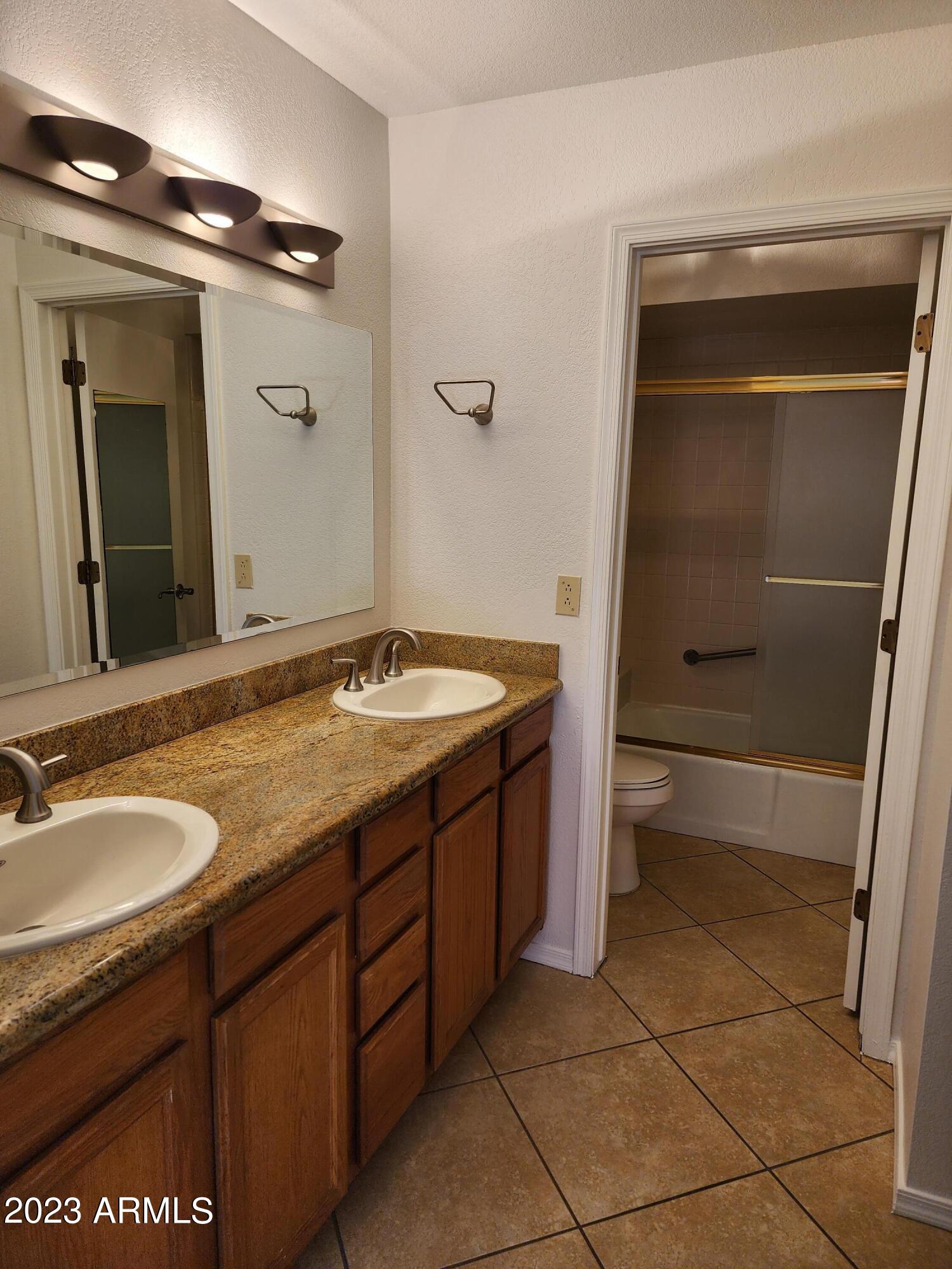 517 West Knox Road Chandler, AZ 85225 - Photo 4 of 14 a bathroom with a granite countertop sink and a mirror