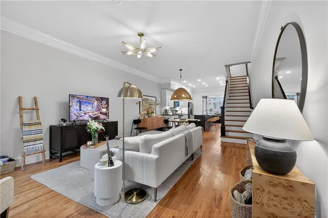 a living room with furniture a rug and a chandelier