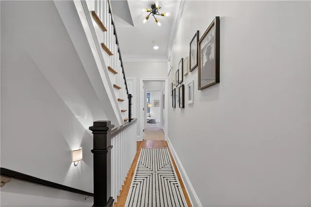 a view of entryway and hall with wooden floor