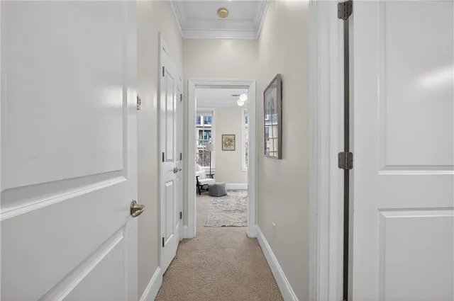 a view of a hallway with wooden floor and bathroom