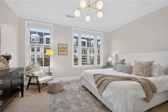 a bedroom with bed couch and window