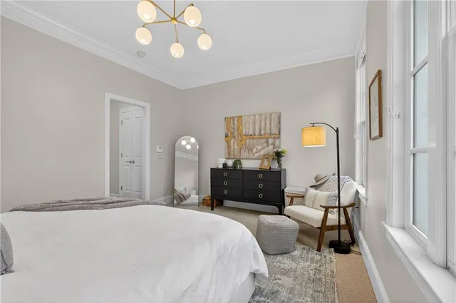 a bedroom with a bed and a chandelier