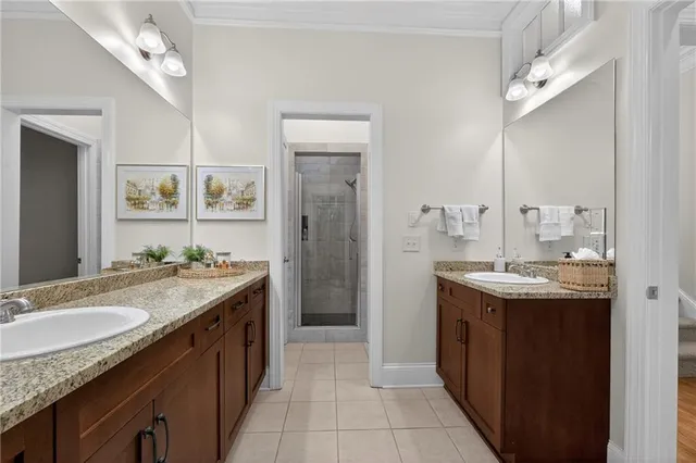 a spacious bathroom with a granite countertop sink a mirror and a bathtub