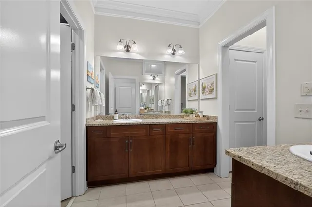 a bathroom with a granite countertop sink a mirror and a vanity