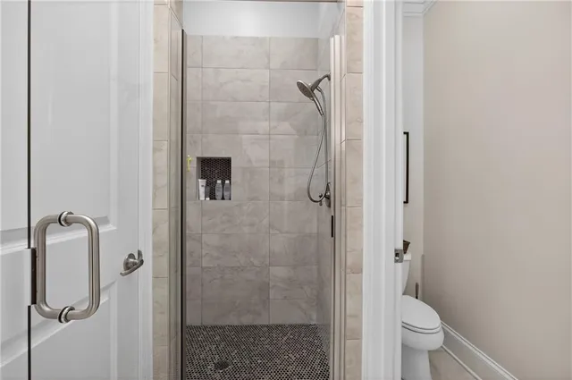 a bathroom with a shower and toilet