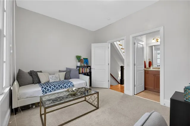 a bedroom with furniture and a rug