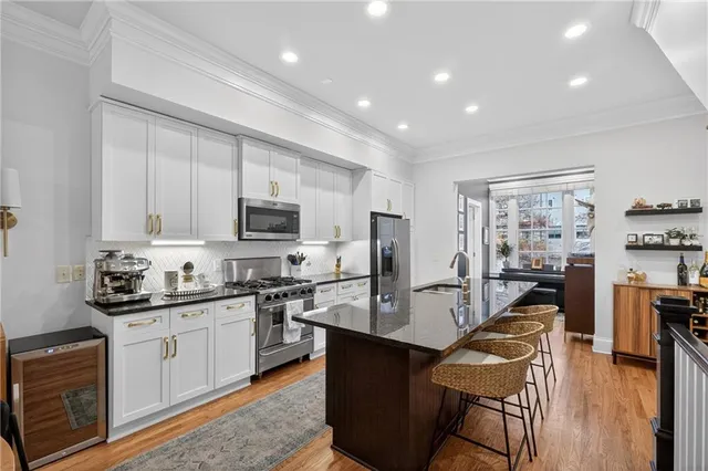a kitchen with stainless steel appliances granite countertop sink microwave and wooden cabinets