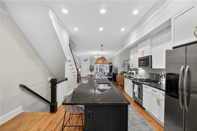a kitchen with sink stove and refrigerator