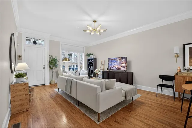 a living room with furniture and a chandelier